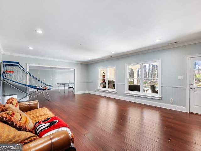 living area featuring visible vents, ornamental molding, wood finished floors, and recessed lighting