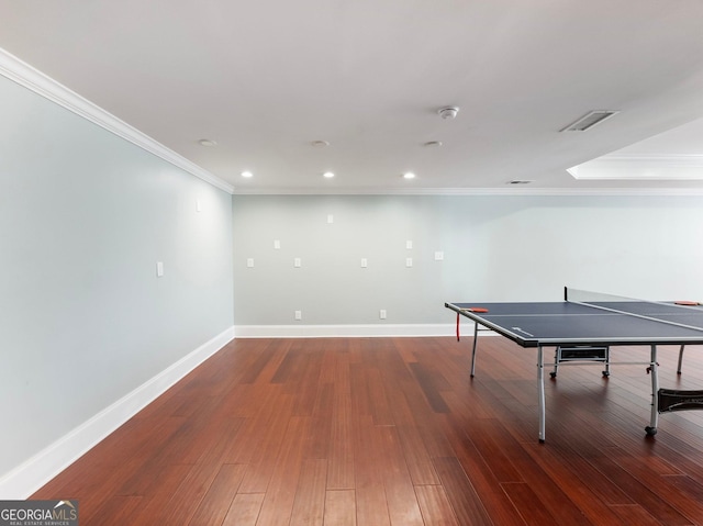 game room featuring wood finished floors, baseboards, visible vents, ornamental molding, and recessed lighting