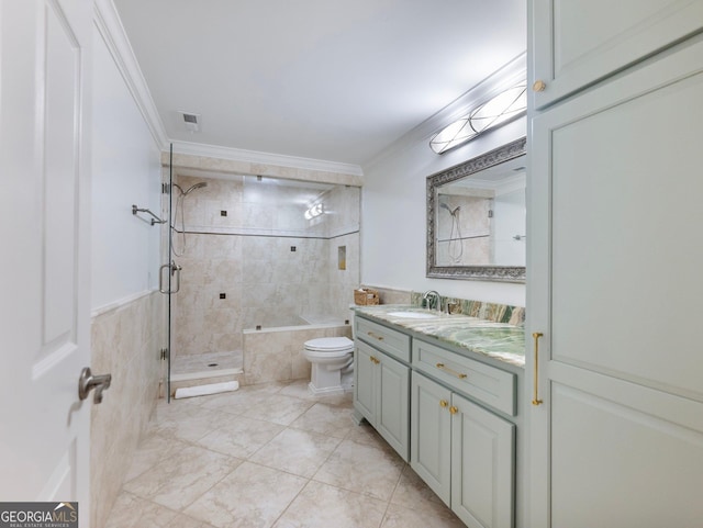 bathroom featuring vanity, ornamental molding, visible vents, and a shower stall