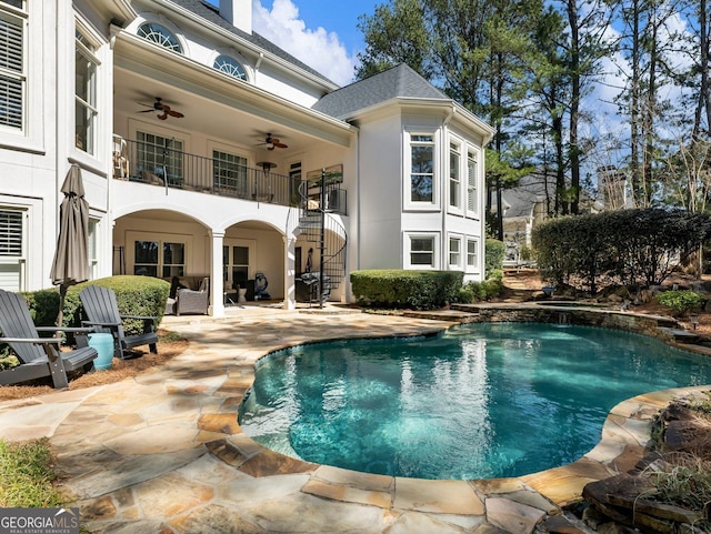 pool featuring a patio area, stairway, and a ceiling fan