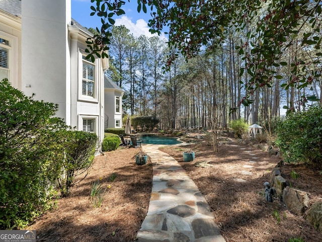 view of yard with an outdoor pool