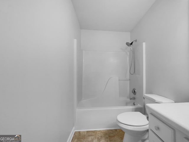 bathroom featuring vanity, shower / tub combination, toilet, and baseboards