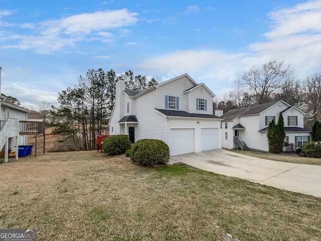 view of front of property featuring a chimney, concrete driveway, a garage, and a front yard