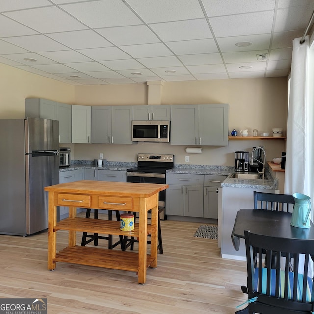107 Oak Way Dr, Eastanollee, GA 30538 - kitchen with a drop ceiling, light wood-type flooring, gray cabinets, stainless steel appliances, and open shelves