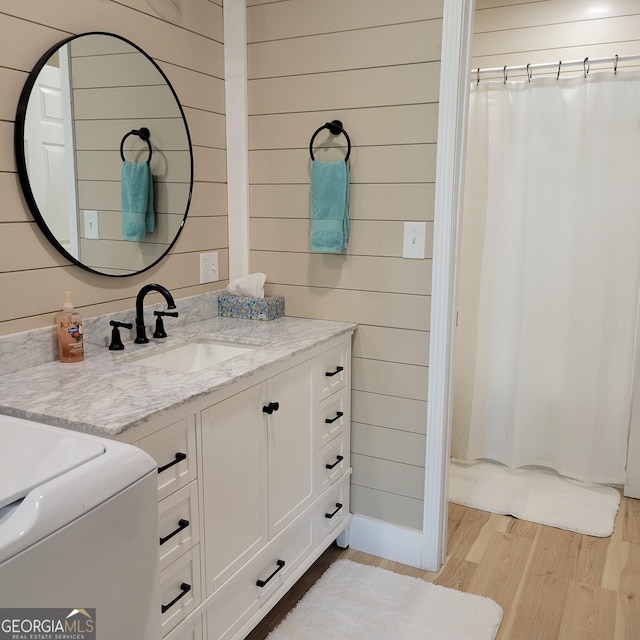 107 Oak Way Dr, Eastanollee, GA 30538 - bathroom featuring wood walls, curtained shower, vanity, and wood finished floors