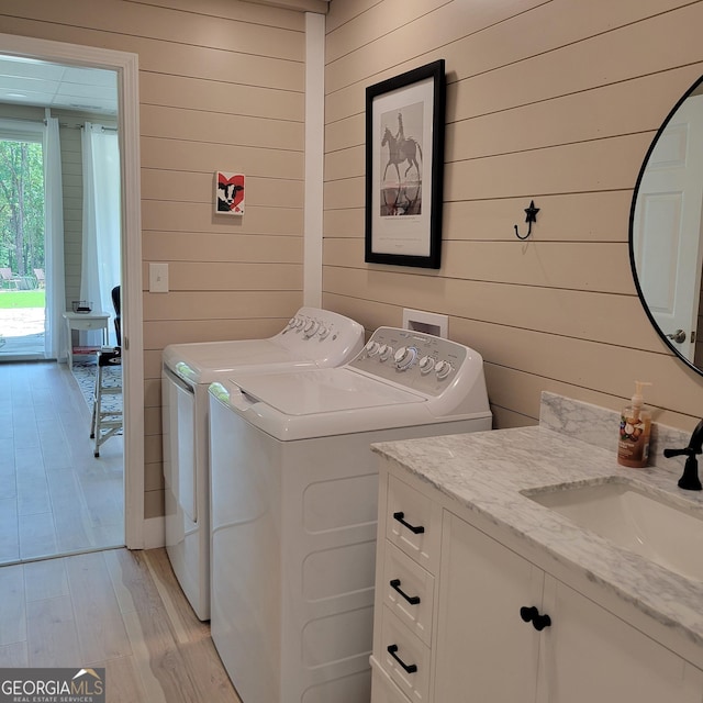 107 Oak Way Dr, Eastanollee, GA 30538 - laundry room featuring light wood finished floors, independent washer and dryer, cabinet space, and a sink