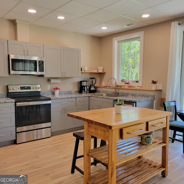107 Oak Way Dr, Eastanollee, GA 30538 - kitchen with gray cabinets, appliances with stainless steel finishes, light wood-type flooring, and open shelves