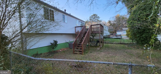 rear view of house featuring stairs, fence, central AC, and a wooden deck