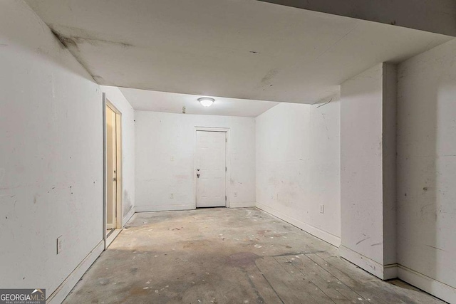 spare room featuring unfinished concrete flooring