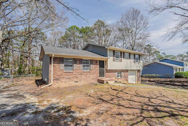 view of front of property featuring brick siding and an attached garage