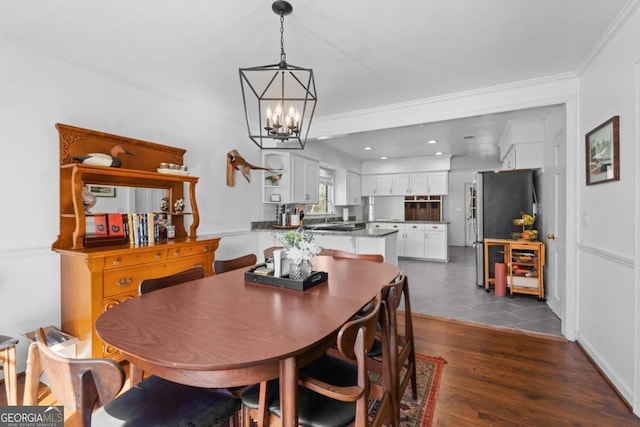 dining space featuring recessed lighting, a chandelier, dark wood-style flooring, and ornamental molding