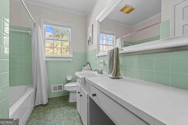 full bath featuring vanity, visible vents, crown molding, toilet, and tile walls