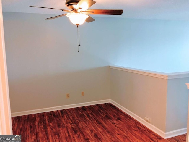 empty room with wood finished floors, baseboards, and ceiling fan