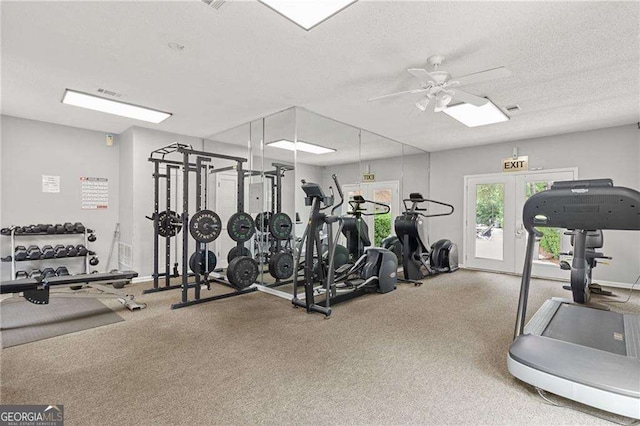 exercise room featuring french doors, baseboards, a textured ceiling, and a ceiling fan
