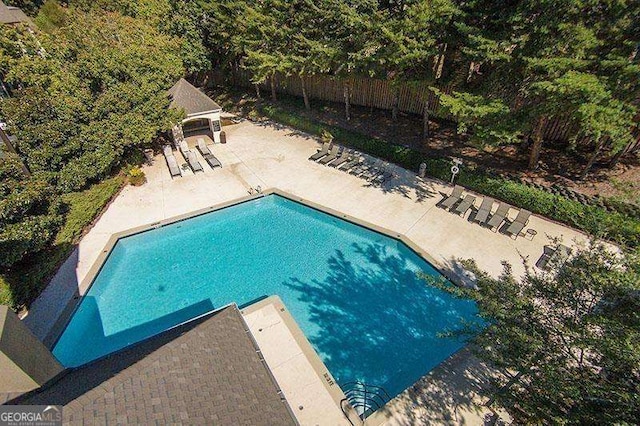 pool featuring a patio and fence