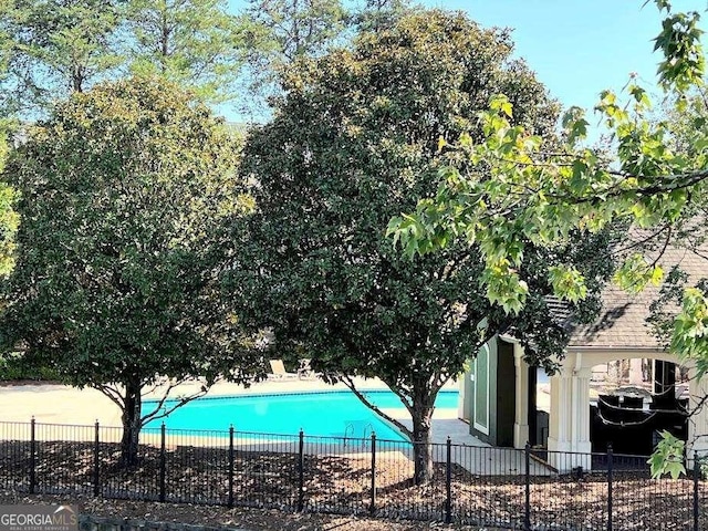 view of swimming pool with a fenced in pool and fence
