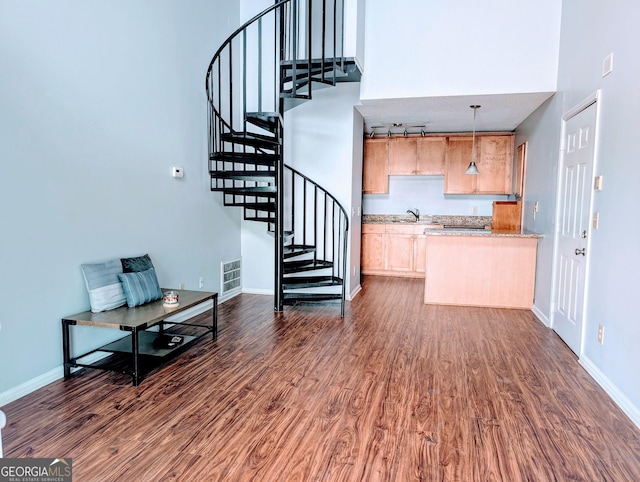 interior space featuring wood finished floors, visible vents, and baseboards
