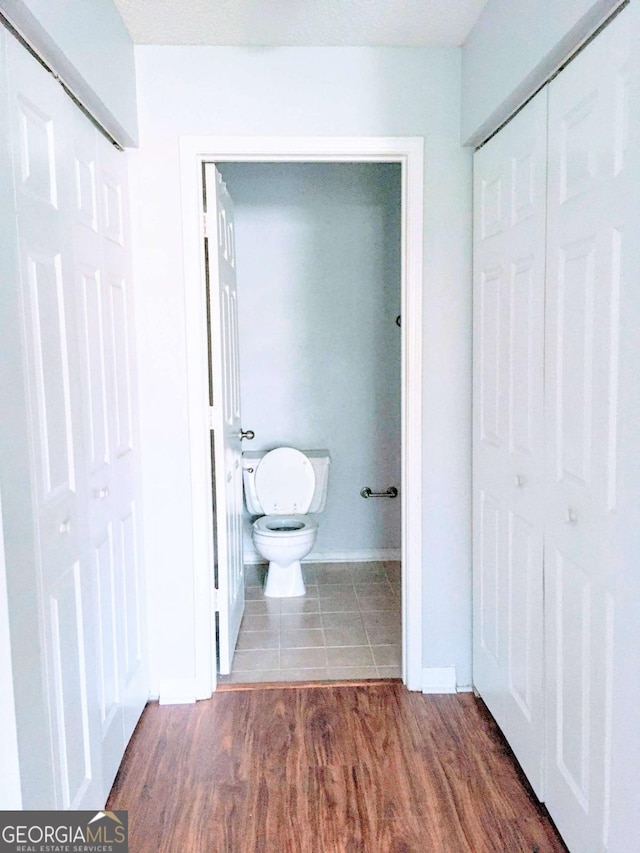 bathroom featuring toilet and wood finished floors