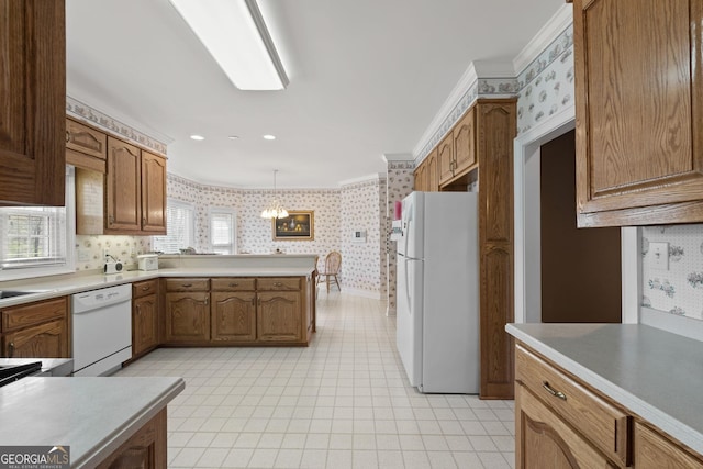 kitchen with wallpapered walls, white appliances, a peninsula, and ornamental molding