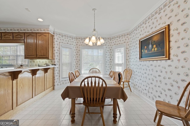 dining room featuring a chandelier, wallpapered walls, baseboards, and ornamental molding