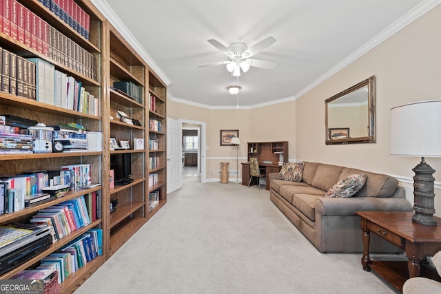 carpeted living area featuring a ceiling fan and ornamental molding