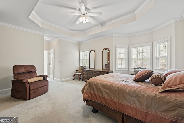 bedroom with baseboards, a raised ceiling, carpet flooring, and crown molding