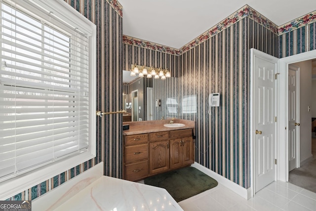 bathroom featuring baseboards, tile patterned flooring, and wallpapered walls