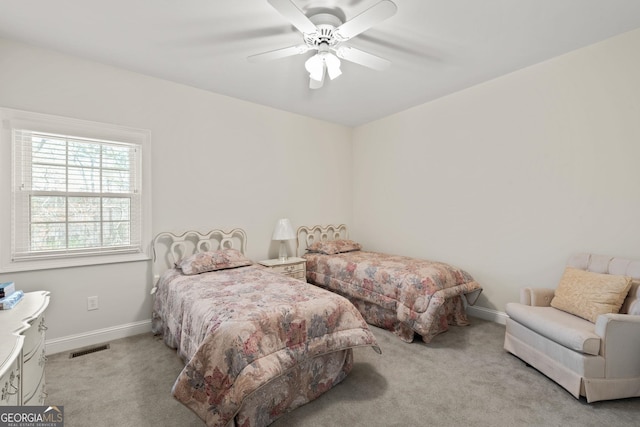 carpeted bedroom with a ceiling fan, baseboards, and visible vents