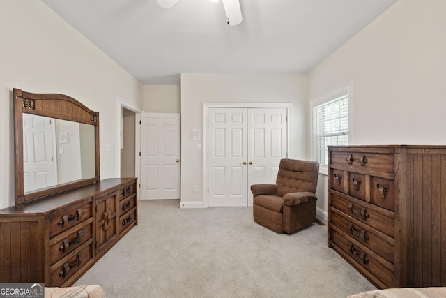 sitting room with light colored carpet, baseboards, and a ceiling fan