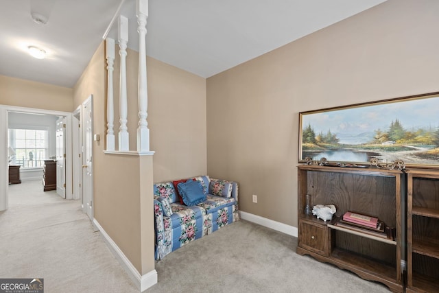 sitting room with carpet, baseboards, and a water view