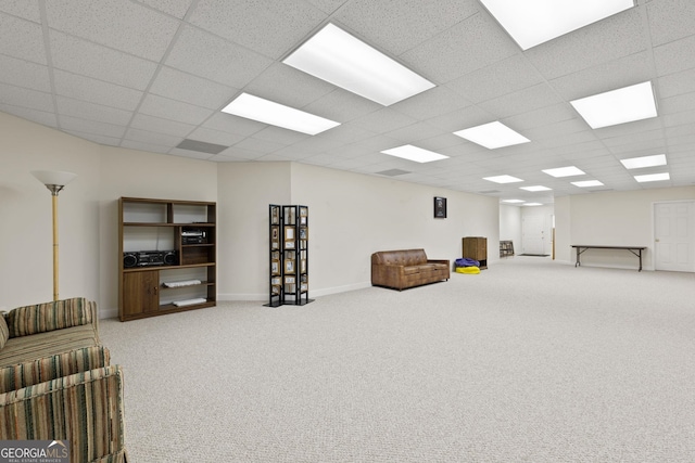 carpeted living room with a paneled ceiling and baseboards