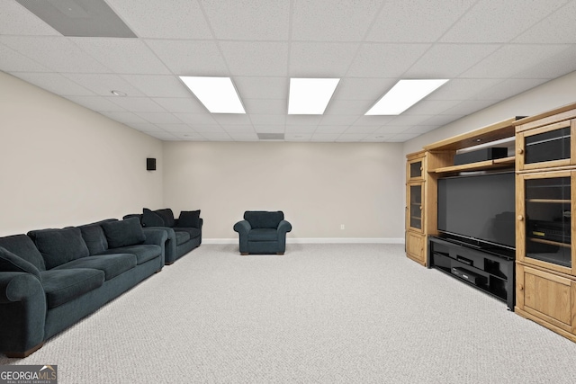 living area with a drop ceiling, baseboards, and carpet floors