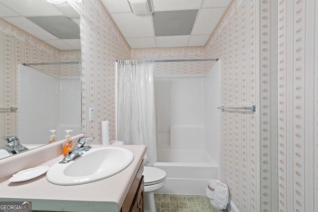 full bath with shower / bath combination with curtain, toilet, wallpapered walls, and a paneled ceiling
