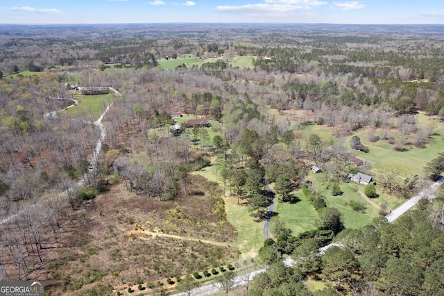 aerial view featuring a wooded view
