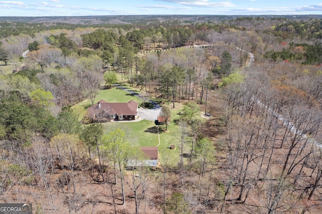birds eye view of property with a view of trees