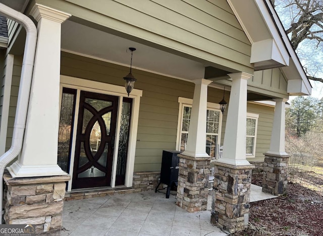 10390 Rivertown Rd, Fairburn, GA 30213 - doorway to property featuring covered porch and stone siding