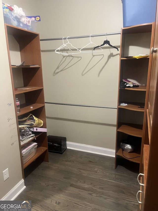 10390 Rivertown Rd, Fairburn, GA 30213 - walk in closet with dark wood-style flooring