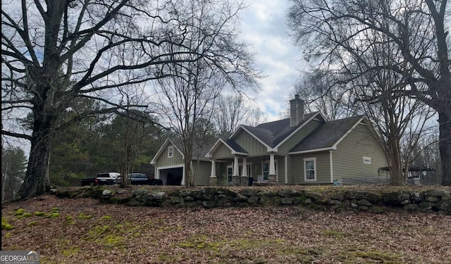 10390 Rivertown Rd, Fairburn, GA 30213 - craftsman house featuring a chimney, covered porch, and board and batten siding