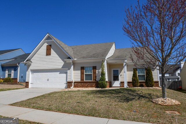 view of front of house with a front lawn, brick siding, driveway, and roof with shingles