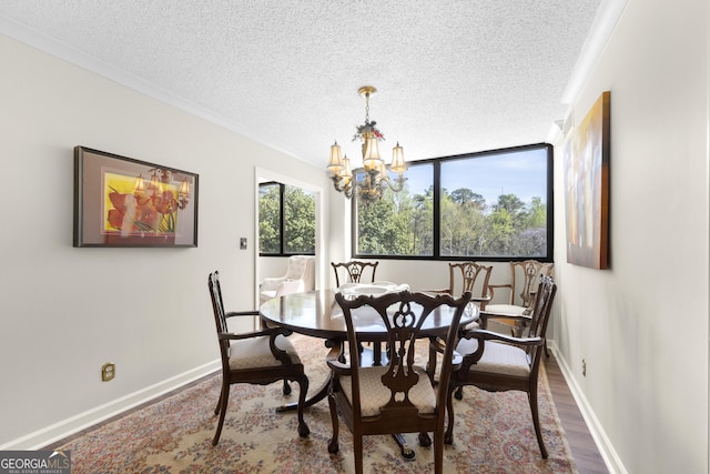 3530 Piedmont Rd NE Unit 3I, Atlanta, GA 30305 - dining area with a textured ceiling, crown molding, dark wood-style flooring, and a chandelier