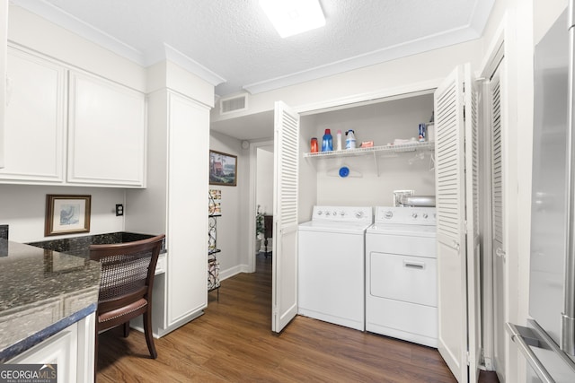 3530 Piedmont Rd NE Unit 3I, Atlanta, GA 30305 - washroom featuring washing machine and dryer, dark wood-style floors, a textured ceiling, and a heating unit