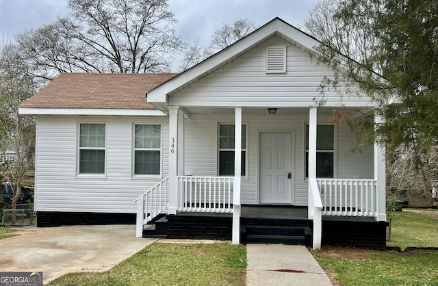 view of front of home with a porch and a shingled roof