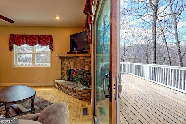 1068 Coleman River Rd, Clayton, GA 30525 - living room featuring wood-type flooring, baseboards, a stone fireplace, and recessed lighting