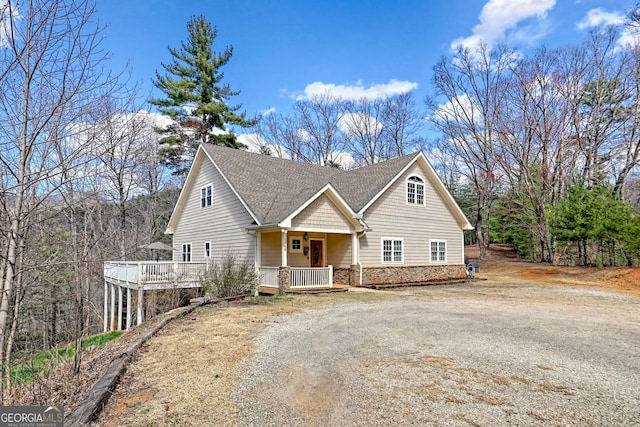 1068 Coleman River Rd, Clayton, GA 30525 - view of front facade featuring a porch, stone siding, dirt driveway, and roof with shingles