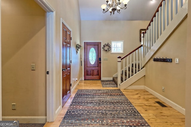 1068 Coleman River Rd, Clayton, GA 30525 - entryway with a chandelier, wood finished floors, stairs, and baseboards