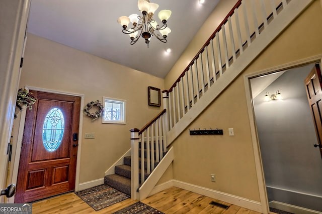 1068 Coleman River Rd, Clayton, GA 30525 - entryway featuring wood finished floors, stairway, baseboards, a chandelier, and lofted ceiling