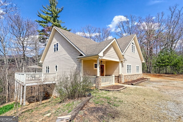 1068 Coleman River Rd, Clayton, GA 30525 - view of front of property featuring a shingled roof, covered porch, stone siding, and a deck