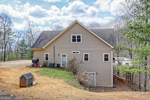 1068 Coleman River Rd, Clayton, GA 30525 - rear view of house featuring a shingled roof, central AC unit, and a yard