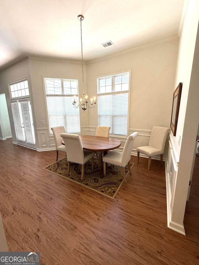 dining space featuring visible vents, plenty of natural light, dark wood-type flooring, and an inviting chandelier