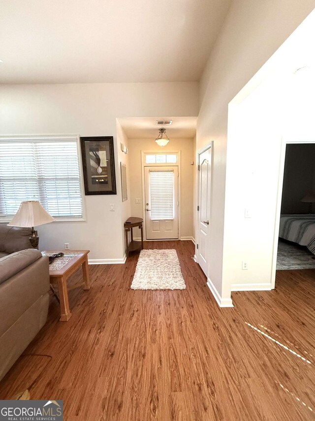 entrance foyer with visible vents, baseboards, and wood finished floors